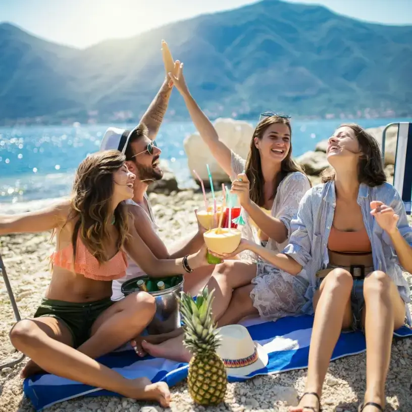 Friends with group travel insurance on holiday at the beach