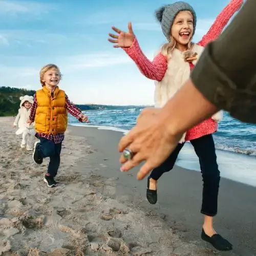 Children with health insurance playing on the beach