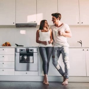 A couple in their apartment kitchen.