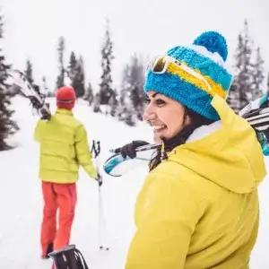 Couple with ski and snowboard cover