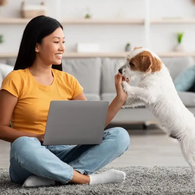 Dog owner feeding treats to her dog