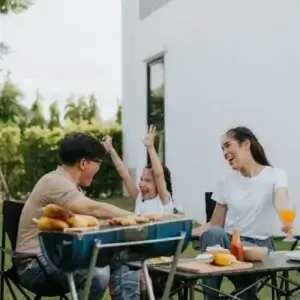 Family enjoying lunch in the backyard of their home.