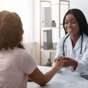 Female doctor comforts patient with PCOS