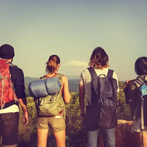 Group of friends hiking with travel insurance for backpackers