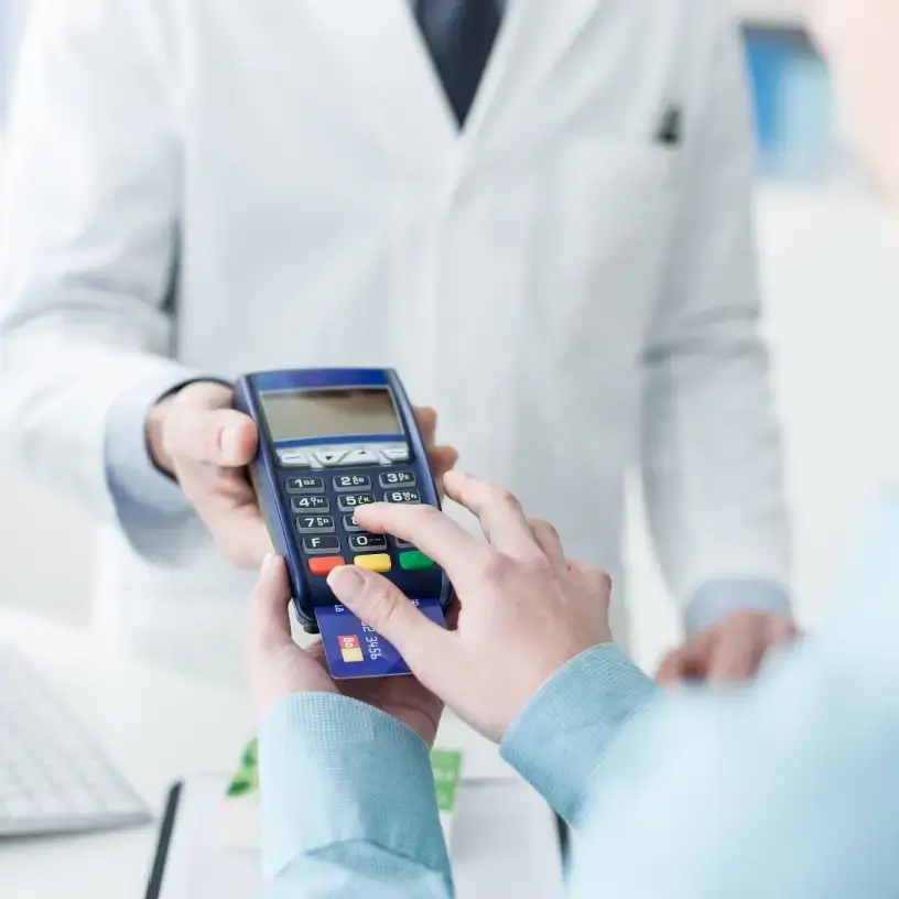 A patient inputting their payment details into a HICAPS terminal