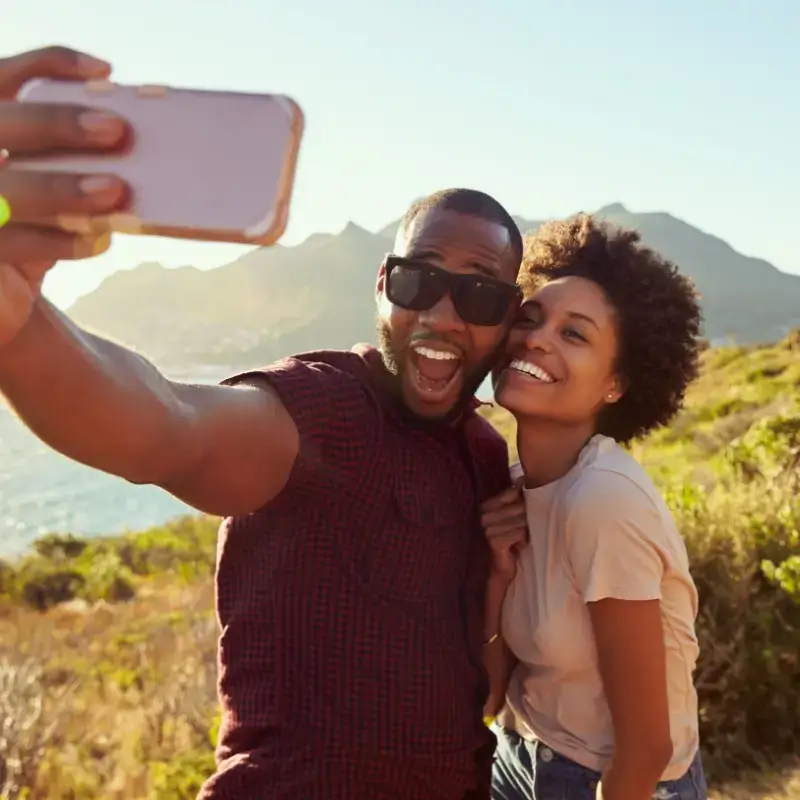 Happy couple taking selfie on holiday