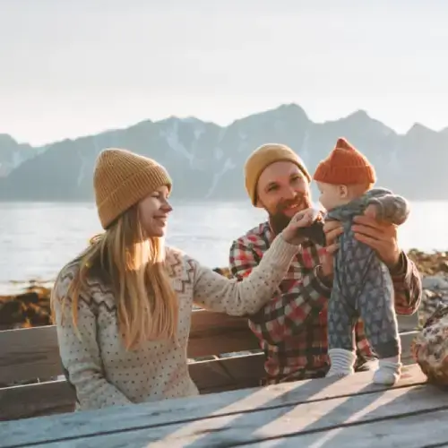Happy family on holiday in Norway with travel insurance with cancellation cover