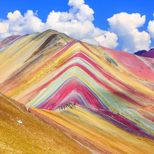 Hikers walking along the Montana de Siete Colores in Peru