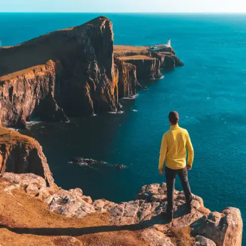 Man standing on a cliff in Scotland UK