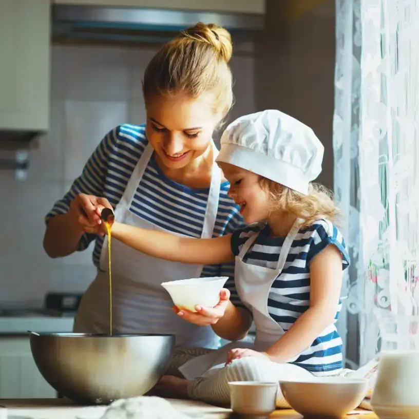 Mother with health insurance for families bakes with daughter