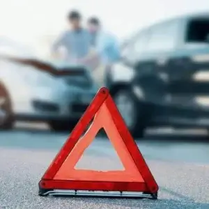 car hazard sign on the roadside of a car accident