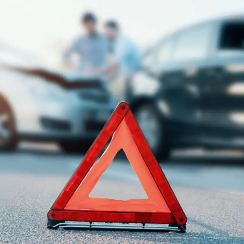 car hazard sign on the roadside of a car accident