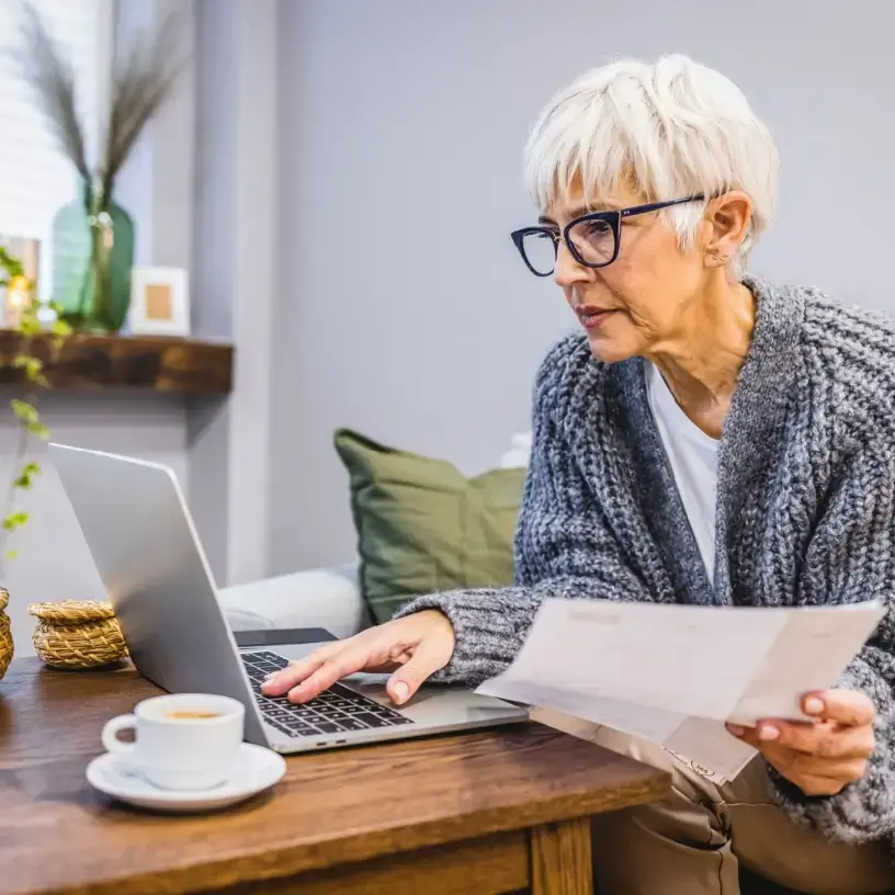 Older woman reading her electricity bill