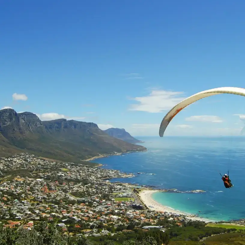 Tourist with travel insurance for South Africa paragliding in Cape Town