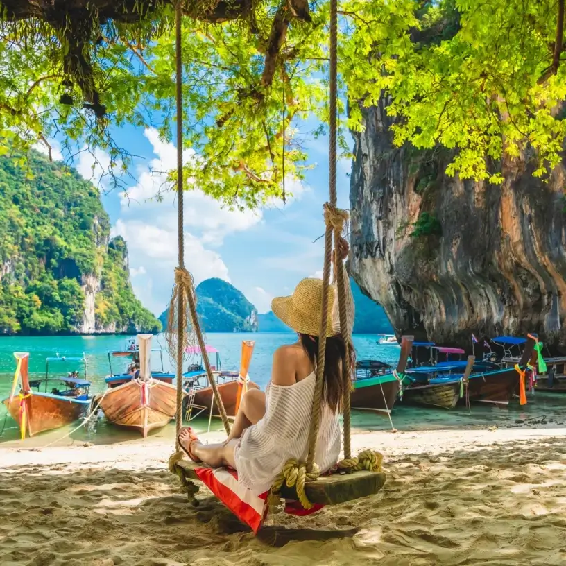Tourist with travel insurance for Thailand relaxing on the beach