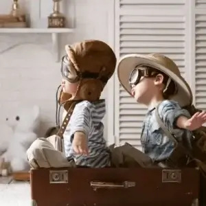 Two children playing and pretending to be on a plane