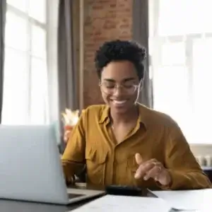 A woman on a laptop, using a calculator