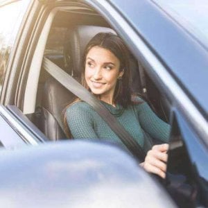 A woman driving a car.