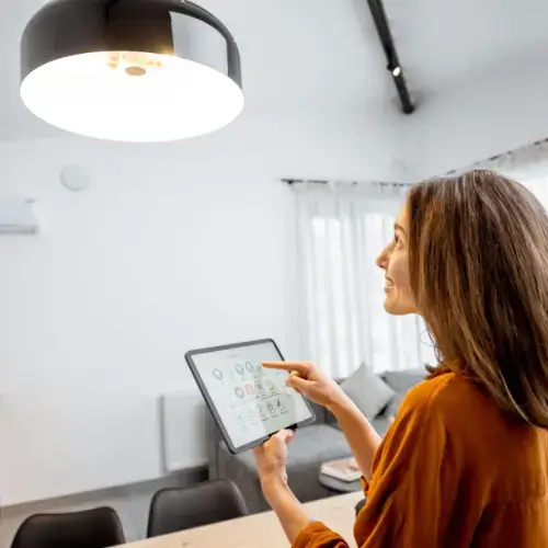 Woman turning off smart light to save electricity