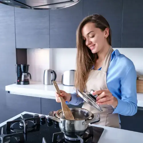 Woman using gas to cook