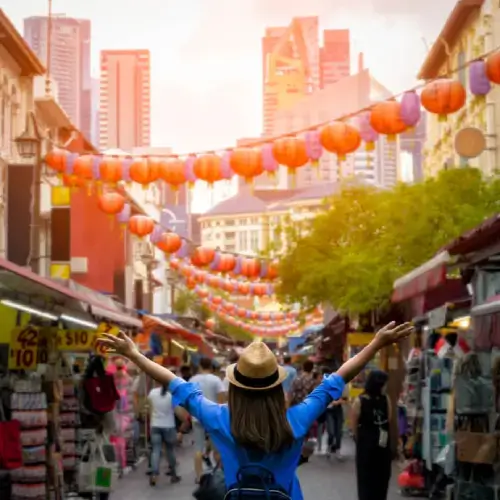 Woman with travel insurance for Singapore at the markets