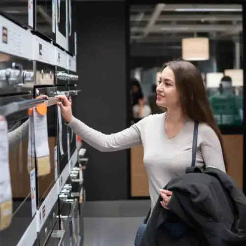 Women comparing gas and electricity ovens