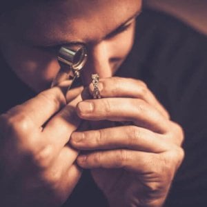 A jeweller inspecting a ring.