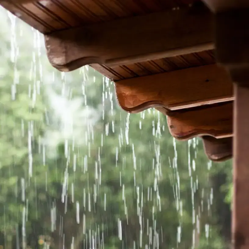 Rain falling on a roof.