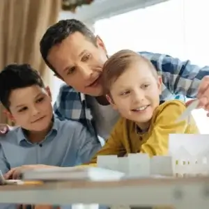 Dad talking to sons about solar feed-in tariffs