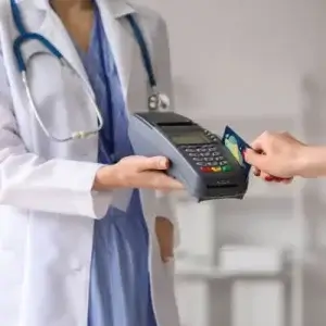 Doctor-takes-payment-after-explaining-hospital-insurance-costs