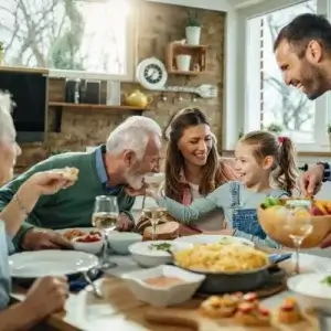 Senior couple sitting at the dining table with their family