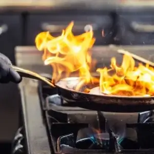 Small business chef cooking on commercial gas stove