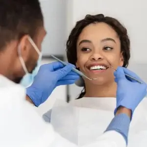 Woman goes to dentist with dental cover