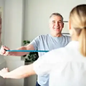 man-exercising-with-physiotherapist