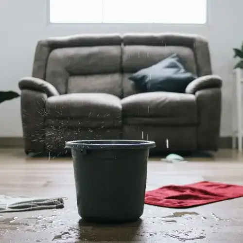 water damage bucket inside home