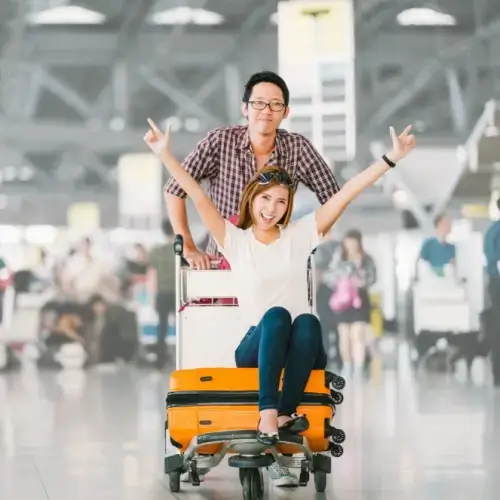 happy couple with luggage