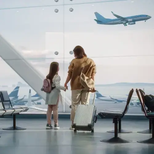 A mother and her daughter waiting at an airport.