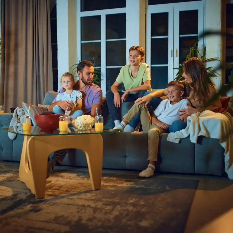 Family watching tv in the evening