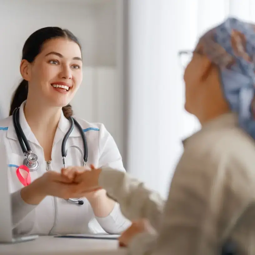 Female doctor comforting female cancer patient