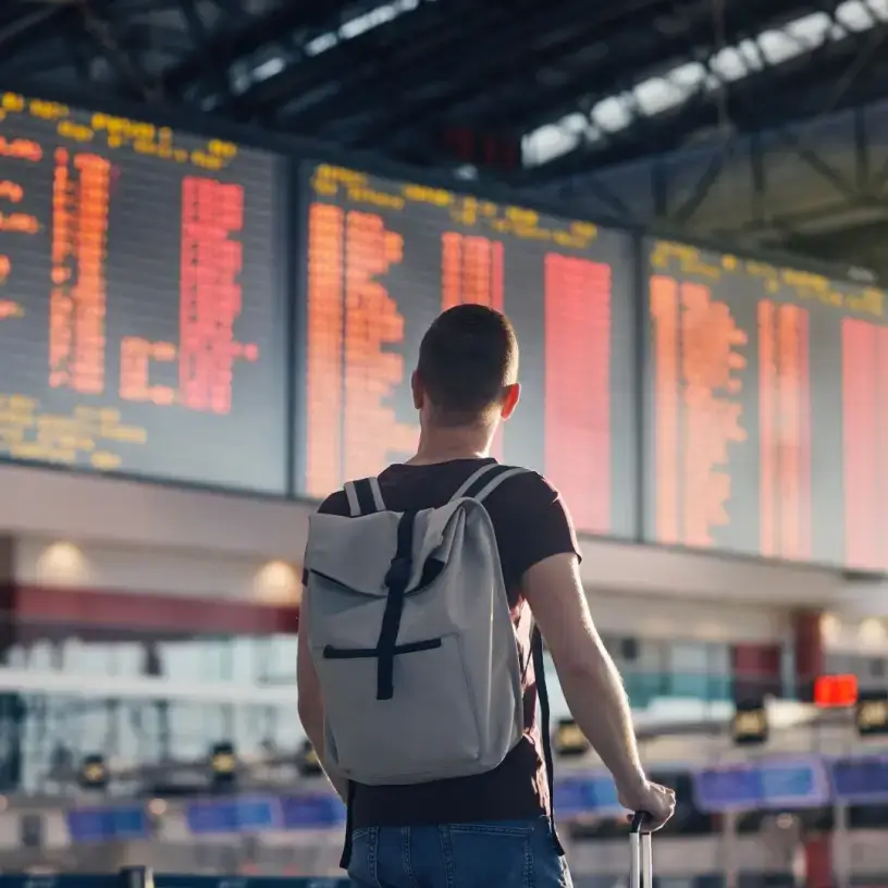 Man looking at departure board airport