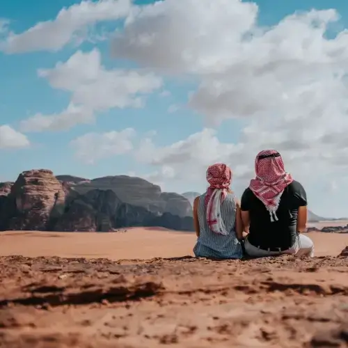 Two tourists in Wadi Rum desert in Jordan Middle East