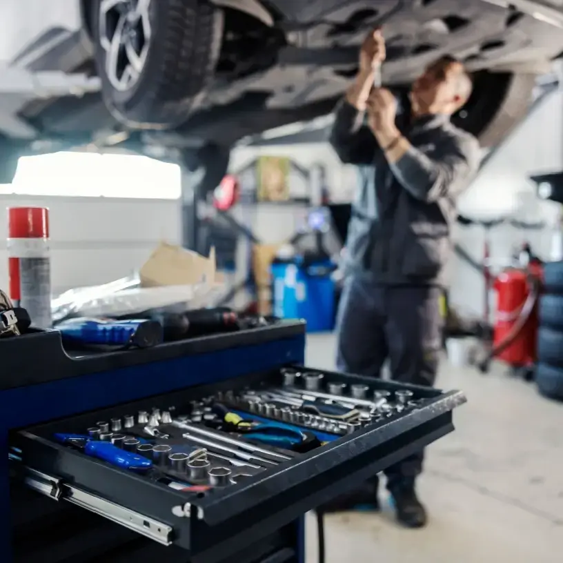 Mechanic working under a car