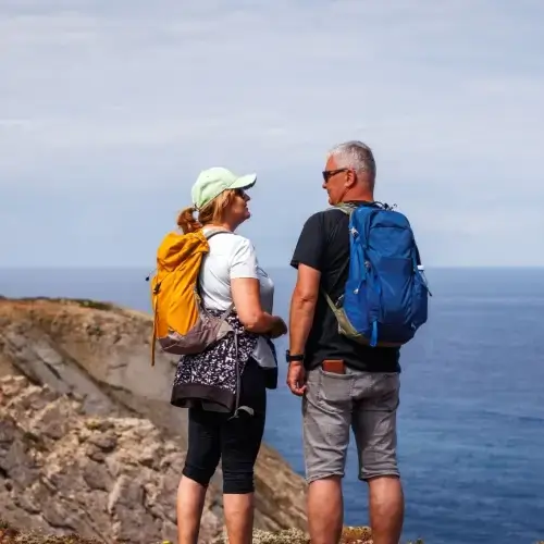 Middle aged couple looking out over cliffs