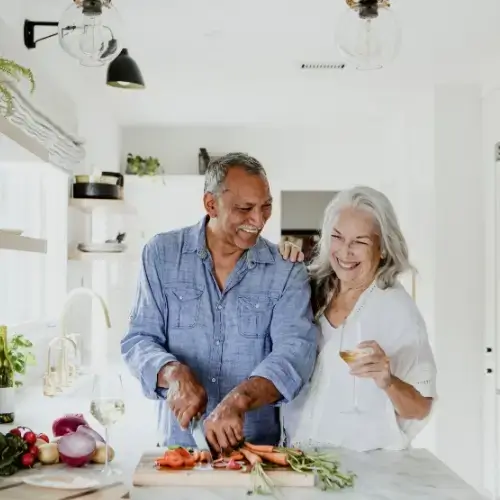 Senior couple cooking in their home kitchen