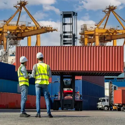 Two workers supervising ship loading
