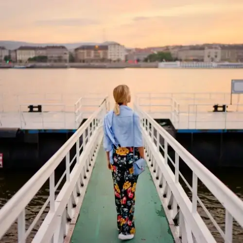 Woman with travel insurance for river cruises on river dock