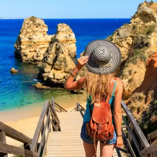 Woman at the beach in Lagos Portugal with travel insurance