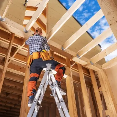 Man building house with sustainable timber material