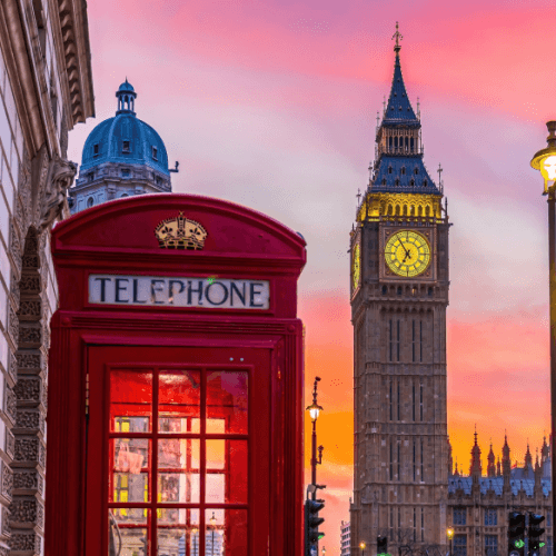 Big Ben tower of Houses of Parliament with telephone boot UK at sunrise