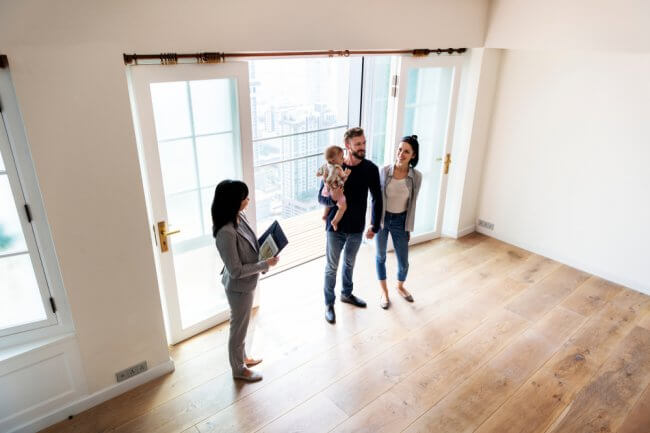 Family being shown around house by real estate agent